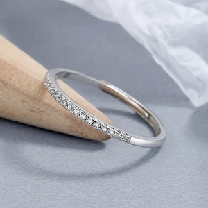 Adjustable S925 sterling silver ring with micro-pave cubic zirconia on a wooden stand