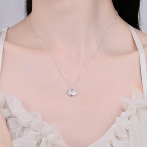 Minimalist 925 silver heart necklace with white mother of pearl on a lace top model