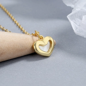925 silver gold heart necklace with white mother of pearl pendant on wooden display