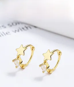 Close-up of gold 925 silver star hoop earrings with round sparkling cubic zirconia stones
