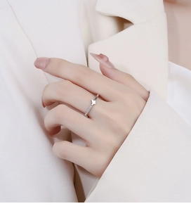 Detailed close-up of a 925 silver butterfly zircon ring worn on a finger