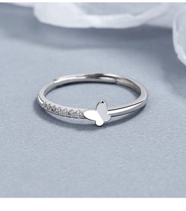 Close-up of 925 silver butterfly ring with cubic zirconia on adjustable open band
