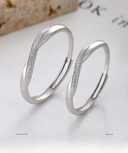 Macro view of S925 sterling silver couple rings with crossed frosted and polished bands