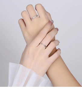 Detail of 925 sterling silver couple rings with frosted finish and micro-set diamonds