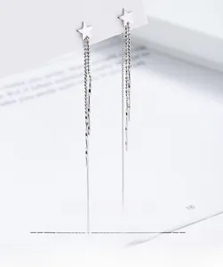 Close-up of S925 sterling silver star tassel ear threads on a white display card