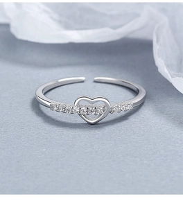 Macro shot of 925 silver heart ring with micro-pave zircons and open adjustable band
