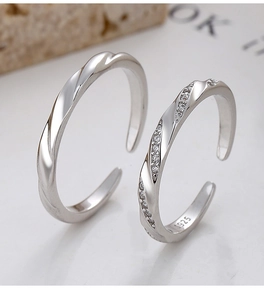 Detailed close-up of 925 sterling silver Mobius rings with twisted texture and zircon inlay