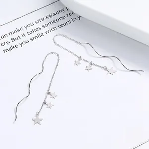 Close-up of 925 sterling silver long tassel ear threads with sparkling star pendants
