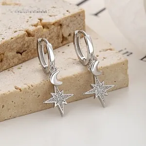 Macro shot of 925 sterling silver star and moon earrings with cubic zirconia stones