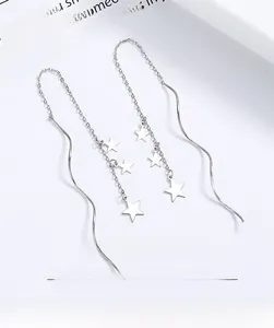 Macro shot of 925 sterling silver star tassel earrings with elegant long wave chains