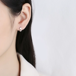 925 silver star hoop earrings with hanging cubic zirconia on a female model's ear