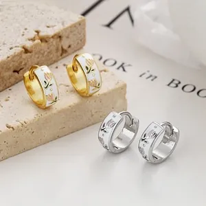 Detailed close-up of 925 sterling silver floral hoop earrings with enamel flower patterns