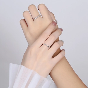 925 sterling silver couple rings with twisted design and cubic zirconia on grey background