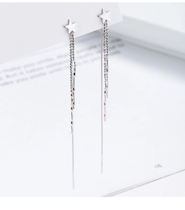Close-up of 925 sterling silver star drop earrings with multi-layer tassel chains