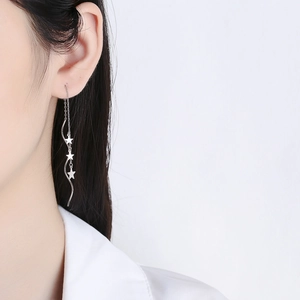 Elegant 925 sterling silver star tassel wave drop earrings on female model