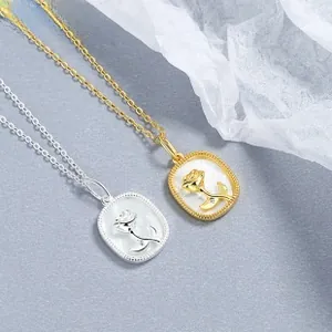 Detail of sunflower pendant with mother-of-pearl base and rose gold sunflower carving