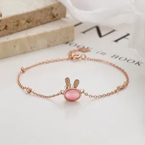 Detail of rose gold rabbit bracelet with pink moonstone and delicate chain