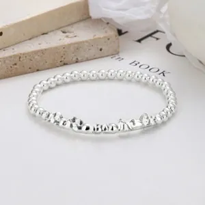 Detailed shot of 925 silver beaded bracelet featuring five colorful smiley face charms