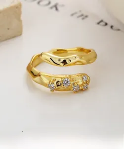 Macro shot of S925 sterling silver bypass ring with 18K gold plating and pavé zircon stones