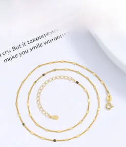 Detail of 925 sterling silver gold plated necklace showing delicate links and bead accents