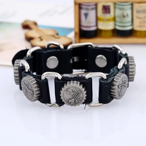 Detail of punk leather bracelet with gear charms and wrench relief pattern buckles