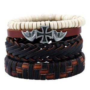 Detail of multi-layer leather bracelet set with wooden beads and metal cross charms