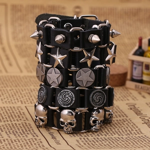 Stack of punk leather bracelets with silver metal star studs and rivets on vintage paper