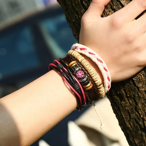 Bohemian multilayer leather bracelet set with pink gemstone and wooden beads on wood