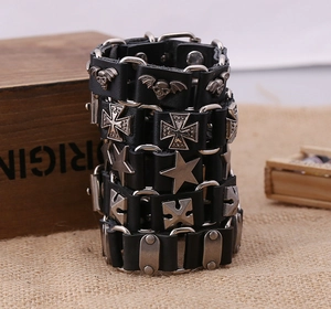Detail of punk leather bracelet with skull and cross charms on vintage burlap