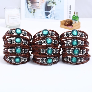Handmade woven 12 constellations leather bracelet set with zodiac charms on white background