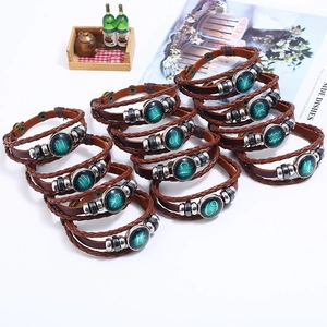 Brown braided leather zodiac bracelets set with twelve distinct glass constellation charms