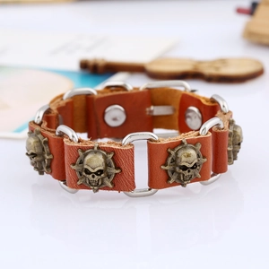 Retro punk leather bracelet with bronze skulls and silver links on white background