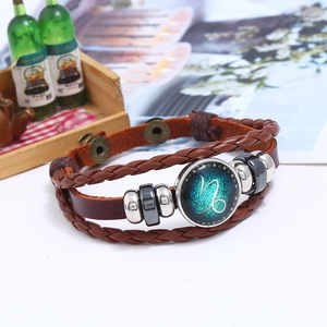 Detailed close-up of Capricorn zodiac sign on a braided multi-layer leather bracelet