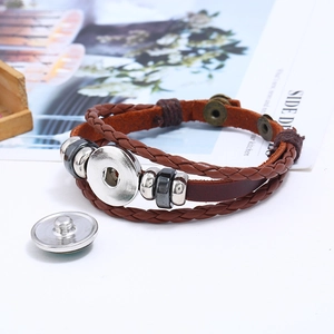 Detail of multilayer brown braided leather bracelet with snap button and metal beads
