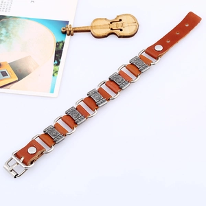 Punk style brown leather bracelet with silver metal rings and embossed decorative plates
