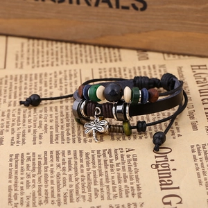 Detailed close-up of a vintage leather dragonfly bracelet on a retro newspaper background