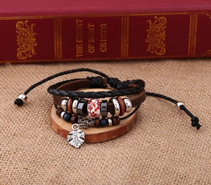 Detail of multi-layer leather bracelet with ceramic flower bead and silver leaf pendant