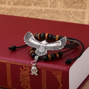 Gothic leather bracelet with silver eagle and skull charms on wooden beads and cords