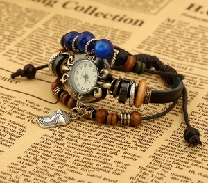 Macro detail of retro cowhide bracelet watch with wooden beads and a cap pendant