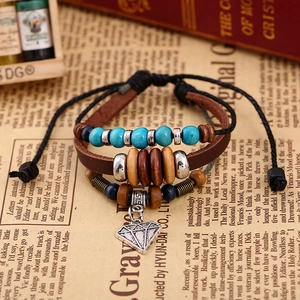Detail of woven leather bracelet with blue beads and geometric diamond alloy pendant