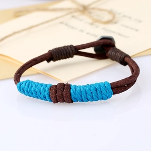 Detailed view of handmade vintage braided leather bracelet with blue and brown weave