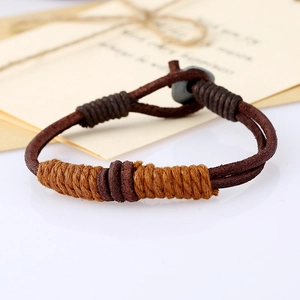 Macro detail of vintage braided brown leather bracelet with handmade rope wrapping texture
