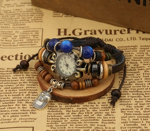 Macro shot of retro quartz watch featuring turquoise beads and metal cap pendant