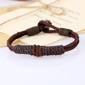 Macro view of vintage brown braided leather bracelet with handcrafted twine details