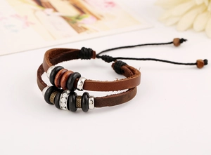 Close-up of vintage double-layer leather bracelet with wooden beads and metallic accents