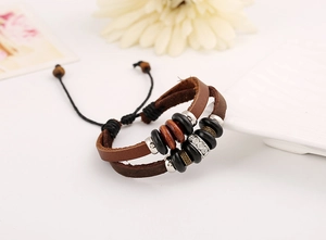 Detail view of multi-layer leather bracelet with wooden beads and sparkling rhinestone ring