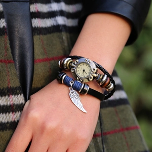 Vintage multi-layer leather bracelet watch featuring bronze wings and quartz dial on wrist