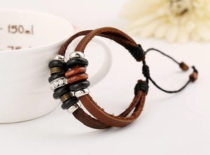 Detail of multilayer vintage leather bracelet with wooden beads and adjustable cord