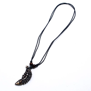 Vintage tribal faux bone resin pendant necklace with wolf tooth style and black wax cord