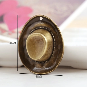 Macro shot of 46x38mm vintage gold alloy hat pendant with detailed brushed metal texture